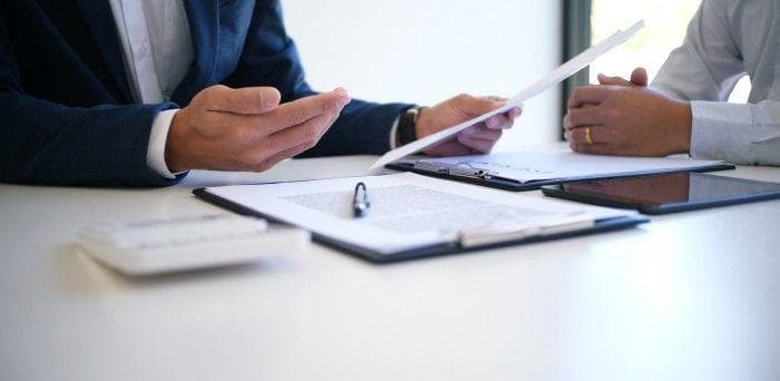 A group at a table reviewing a paper